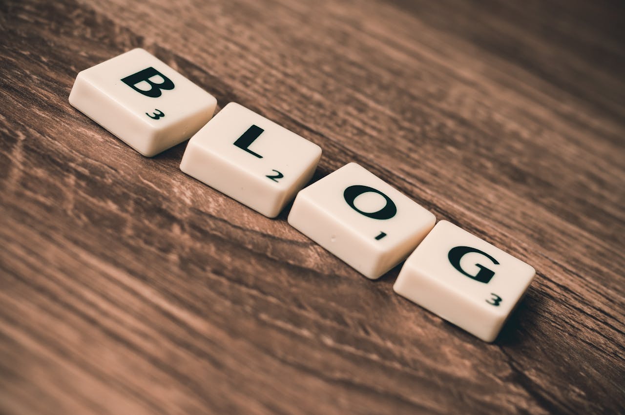 About Scrabble tiles spelling BLOG on a wooden background, symbolizing creativity and writing.
